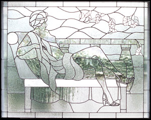leaded art glass window of lady lounging on a chaise