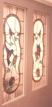 stained and leaded glass hummingbird with flowers and butterfly with flowers windows